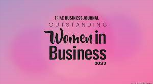  image with pink background and black text that says Triad Business Journal Outstanding Women in Bus